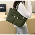 Side view of large green corduroy tote bag with zipper pockets for casual daily use - Green