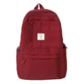 Maroon quilted backpack for women featuring square pattern and front zipper pocket - Red