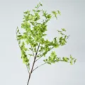 Lifelike artificial orange jasmine branch with vibrant green leaves and yellow flowers - Green