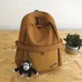 Casual large capacity solid color backpack for women and students with cute monkey pendant. - One Size / Orange