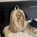 Stylish large capacity khaki student backpack with unique drawstring front pocket design - Khaki