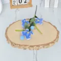 Detailed view of artificial 3-head blue poppy branch on a wooden display slab - Blue