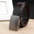 Close-up detail of a dark brown leather belt with a brushed metal automatic buckle. - Brown (Style 05)