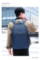 Man wearing a large capacity navy blue casual backpack in an urban setting for daily commute - One Size / Blue