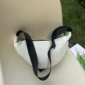 A minimalist white crescent dumpling crossbody bag with an adjustable black strap - White