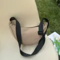 Stylish minimalist beige crescent crossbody bag with adjustable black nylon strap for outdoors - Khaki