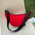 Minimalist vibrant red crescent crossbody dumpling bag with adjustable black shoulder strap - Red