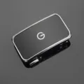 Close-up detail of a premium glossy black zinc alloy belt buckle with a white 'G' logo. - Inner-wear Style / Silver