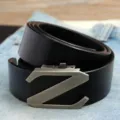 Detailed macro view of a men's black leather belt featuring a silver Z-shaped automatic buckle - Black (Style 03)