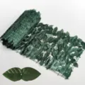 Detailed view of artificial green leaf hedge roll with mesh backing and leaf structure - Dark Green