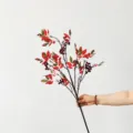 Detailed close-up view of artificial Nandina berry branch for wedding and home decor - Red
