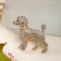 Close-up of a golden poodle brooch fully encrusted with sparkling clear rhinestones - Gold Puppy Brooch