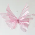 Detailed macro view of a pink sheer gauze artificial butterfly with pearl body accents - Light Pink