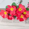 Detailed close-up of vibrant red artificial cosmos flowers, showcasing delicate petal texture. - One Unit / Red