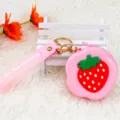 Cute pink silicone strawberry coin purse and AirPods case with gold keychain attachment - Strawberry