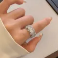 Detailed macro view showing a sparkling full zircon open ring with irregular edges worn on a hand - R5207 Full Diamond Zirconia Open Ring