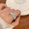 Detailed macro shot of an elegant silver-toned zircon and pearl open ring on finger - R5166 Pearl Zirconia Open Ring