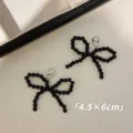 Close-up of black beaded bow charms with silver lobster clasps, sized 4.5 by 6 cm - A70 Black Bow Style / 1 Pair (4.5x6cm)