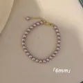 Elegantes 6mm lila rosa Perlenarmband mit verstellbarem goldfarbenem Verschluss-Design - Armband / 6mm / Lila