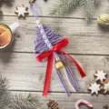 Handmade purple macrame Christmas tree ornament with a red bow and gold bell detail - 30cm/11cm / Light Purple