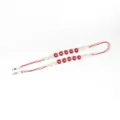 Red and white bohemian woven phone strap with red flower accents for crossbody style - Red White