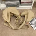 Two beige dumpling crossbody bags in large and small sizes on a carpeted floor - Light Khaki
