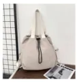 Casual nylon backpack with large capacity, drawstring closure, and comfortable shoulder straps. - Beige