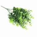 Artificial eucalyptus money leaf plant branch detail showing realistic green foliage texture. - 7-Prong 42-Leaf Flocked Eucalyptus