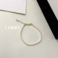 Detail view of a 3mm white pearl bracelet with gold-tone extension chain and clasp - Bracelet (A74)