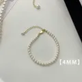 Detailed view of 4mm white pearl bracelet featuring a gold adjustable clasp and chain - Bracelet (A75)