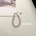 Detailed view of 6mm purple pearl necklace with a delicate golden clasp and extension chain. - Bracelet (A82)