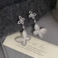 Elegant French retro butterfly drop earrings featuring shimmering mother of pearl detail - Mother Of Pearl Double Butterfly Studs (R2733)