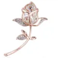 Close-up of elegant rose gold flower brooch featuring crystal petals and rhinestones - Gold