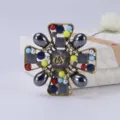 Close-up of vintage palace style cross brooch with colorful beads and rose motif - Antique Gold Multicolor Hollow Cross (Style 9)