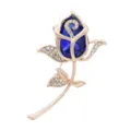 Detailed view of an elegant rose flower brooch featuring a deep blue crystal and small rhinestones. - Sapphire Blue