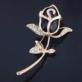 Close-up of elegant rose brooch with large purple crystal and clear rhinestones. - Purple