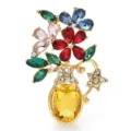 Detailed view of elegant floral vase brooch with colorful sparkling crystals - Yellow