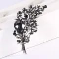 Close-up of elegant black crystal bouquet brooch with intricate rhinestone details - Black