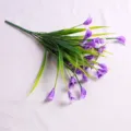 Detailed view of artificial purple Calla Lily flower bunch with realistic green leaves - Purple