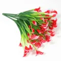 Detailed macro view of red calla lily artificial flowers with green stems - Red