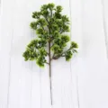 Detailed view of artificial green pine branch with realistic needle clusters - 29目罗汉松 / Green