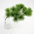 Detail of realistic artificial pine branch greenery in a clear glass vase for decor - 大松针 / Dark Green