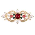 Exquisite close-up of vintage Baroque palace style brooch with red center gem and pearls - Ruby Red