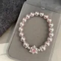 Close-up of pink pearl bracelet with sparkling heart-shaped zircon pendant on velvet - Pink Heart Zirconia Artificial Pearl Bracelet (R0017) / Pink