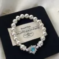Elegant white pearl elastic bracelet featuring a sparkling blue heart zircon pendant - Blue Heart Style (R5681) / Blue