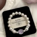 Detail shot of elegant amethyst and pearl bracelet on a black velvet jewelry pad. - Natural Oval Amethyst Artificial Pearl Bracelet (R1683) / Purple
