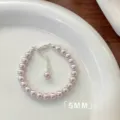 Close-up of elegant 5mm pink pearl bracelet with silver-tone lobster clasp and extension - Bracelet / 6mm / Manta Purple