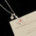 Detailed macro view of silver star pendant necklace with pink zircon and sunflower charm - Pink Star Necklace (R5584)