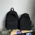 Pair of minimalist black waterproof nylon backpacks in two sizes for school and travel - L / Black