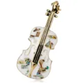 Vintage musical instrument brooch featuring white enamel and colorful shell inlay - White